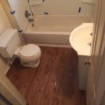 Finished bathroom with hardwood floors