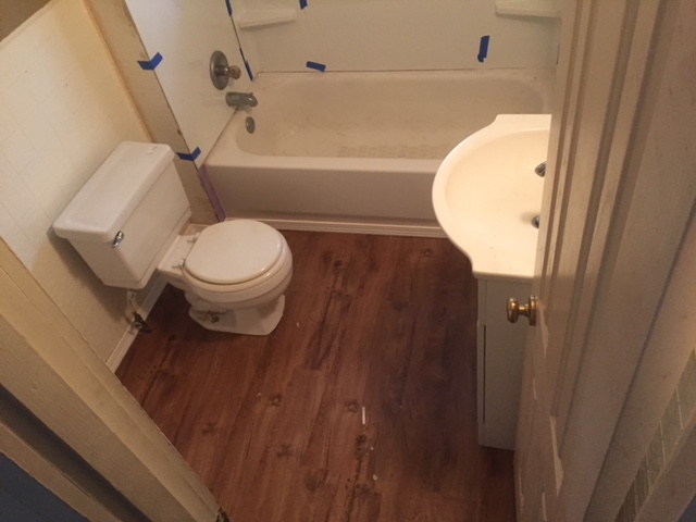 Finished bathroom with hardwood floors